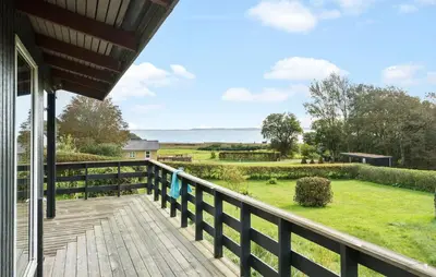 a deck with a view of the ocean from a house at Amazing Home In Øster Assels With Wifi in Øster Assels