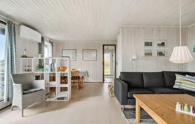 a living room with a couch and a table at Amazing Home In Øster Assels With Wifi in Øster Assels