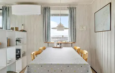 a white dining room with a table and chairs at Amazing Home In Øster Assels With Wifi in Øster Assels