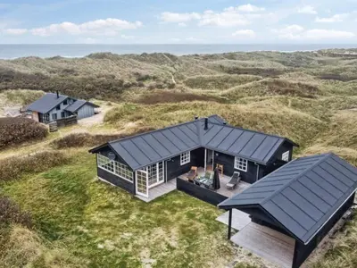 an overhead view of a black house in a field at Holiday Home Merina - 150m from the sea by Interhome in Løkken