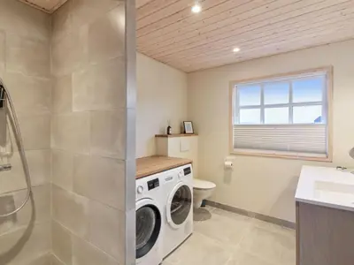 a laundry room with a washer and dryer at Holiday Home Merina - 150m from the sea by Interhome in Løkken