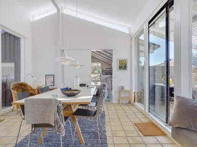 a dining room with a table and chairs at Holiday Home Annrike - 400m from the sea by Interhome in Saltum