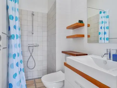 a bathroom with a toilet and a sink and a shower at Holiday Home Annrike - 400m from the sea by Interhome in Saltum