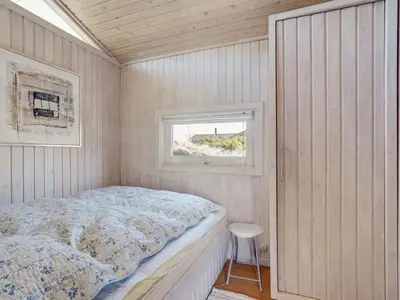 a small bedroom with a bed and a window at Holiday Home Nikodina - 200m from the sea by Interhome in Saltum