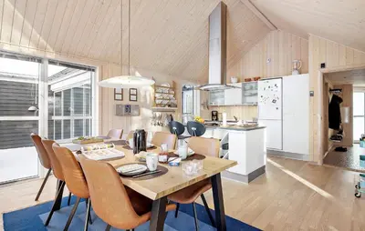 a kitchen and dining room with a table and chairs at Amazing Home In Farsø With Sauna in Farsø