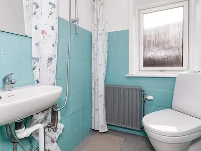 a bathroom with a sink and a toilet and a window at 2 person holiday home in Snedsted-By Traum in Snedsted