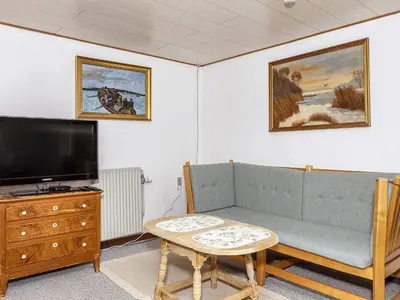 a living room with a couch and a flat screen tv at 2 person holiday home in Snedsted-By Traum in Snedsted