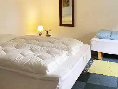 a large white bed sitting in a room at 2 person holiday home in Snedsted-By Traum in Snedsted