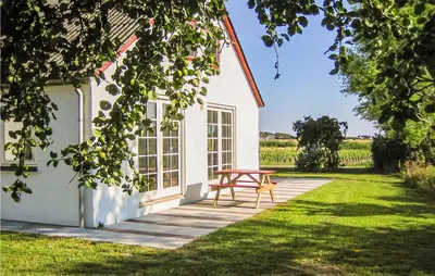 a picnic table in front of a white house at 4 Bedroom Lovely Home In Ranum in Ranum