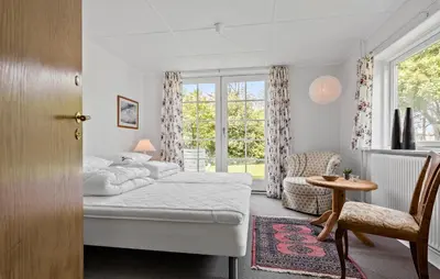 a bedroom with a bed and a table and a chair at 4 Bedroom Lovely Home In Ranum in Ranum