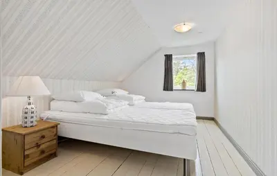 a white bedroom with a bed and a window at 4 Bedroom Lovely Home In Ranum in Ranum