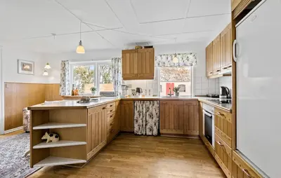 a kitchen with wooden cabinets and a large island at 4 Bedroom Lovely Home In Ranum in Ranum