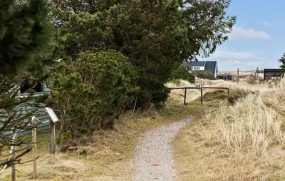 a dirt road next to a tree and a fence at Lovely Home In Thisted With Kitchen in Thisted