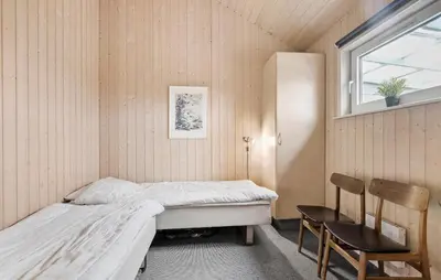 a bedroom with a bed and a window and a chair at Lovely Home In Thisted With Kitchen in Thisted