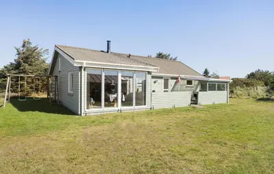 a house with sliding glass doors on a yard at Lovely Home In Thisted With Kitchen in Thisted