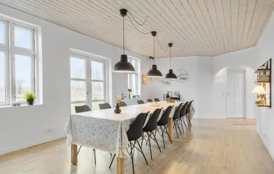 a kitchen and dining room with a table and chairs at Nice Home In Roslev With Kitchen in Roslev