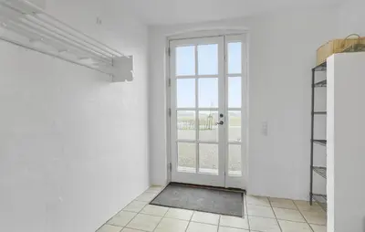 an empty room with a door and a window at Nice Home In Roslev With Kitchen in Roslev