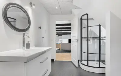 a white bathroom with a sink and a mirror at Nice Home In Roslev With Kitchen in Roslev