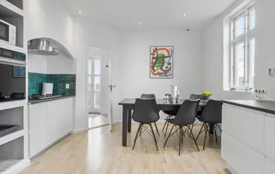 a kitchen with a table and some black chairs at Nice Home In Roslev With Kitchen in Roslev