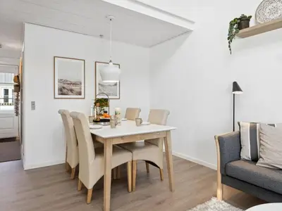 a dining room and living room with a table and chairs at Apartment Milly - 150m to the fjord by Interhome in Vestervig