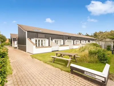 a picnic table and a bench in front of a building at Apartment Milly - 150m to the fjord by Interhome in Vestervig