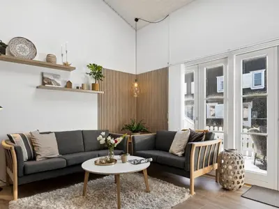a living room with a couch and a table at Apartment Milly - 150m to the fjord by Interhome in Vestervig