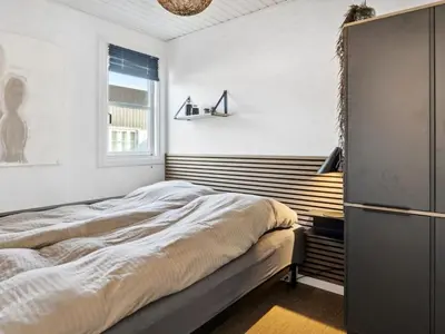 a bedroom with a bed and a window at Apartment Milly - 150m to the fjord by Interhome in Vestervig