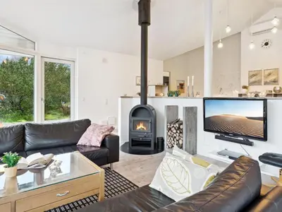 a living room with a couch and a fireplace at Holiday Home Guri - 600m to the fjord by Interhome in Fur