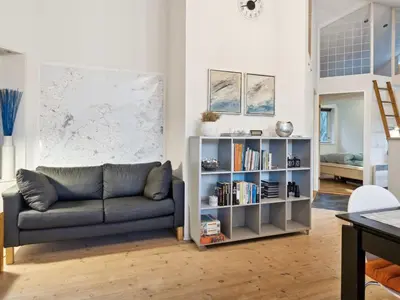 a living room with a couch and a book shelf at Holiday Home Guri - 600m to the fjord by Interhome in Fur