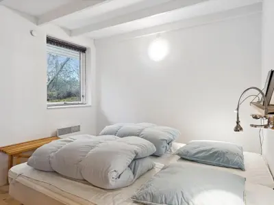 a group of pillows on a bed in a room at Holiday Home Guri - 600m to the fjord by Interhome in Fur