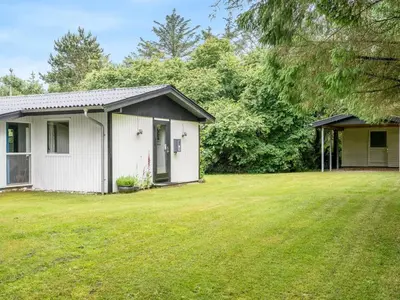a small white house with a large yard at Holiday Home Suri - 200m to the fjord by Interhome in Thyholm