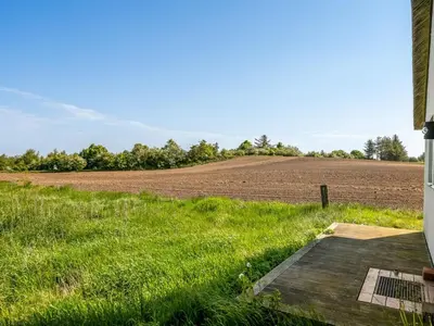 a farm field with a dirt field in the background at Holiday Home Annli - 800m to the fjord by Interhome in Fur