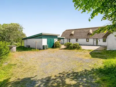an old white barn with a green roof at Holiday Home Annli - 800m to the fjord by Interhome in Fur