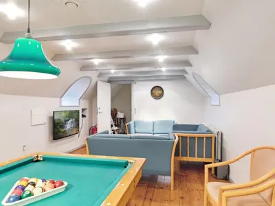 a living room with a pool table and chairs at Holiday Home Annli - 800m to the fjord by Interhome in Fur