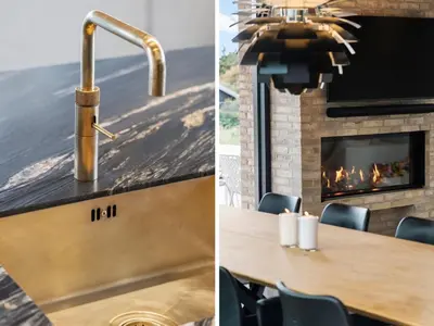 a kitchen with a fireplace and a table and a sink at Holiday Home Ilja - 800m from the sea by Interhome in Blokhus