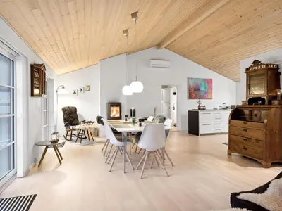 a kitchen and living room with a table and chairs at Holiday Home Svante - 600m from the sea by Interhome in Blokhus