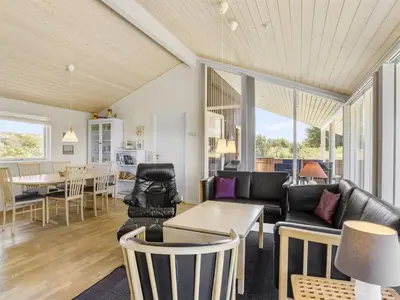 a living room with a couch and a table at Holiday Home Joris - 1-5km from the sea by Interhome in Løkken