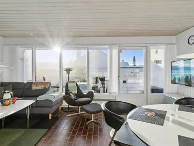 a living room with a couch and a table at Holiday Home Leny - 900m from the sea by Interhome in Pandrup