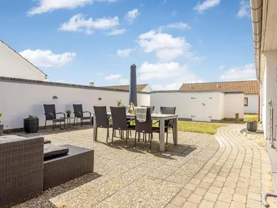 a patio with a table and chairs in a yard at Holiday Home Leny - 900m from the sea by Interhome in Pandrup