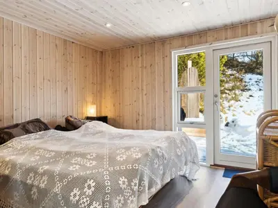 a bedroom with a bed and a window at Holiday Home Lagho - 500m from the sea by Interhome in Pandrup