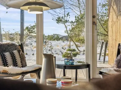 a living room with a table and a window at Holiday Home Lagho - 500m from the sea by Interhome in Pandrup