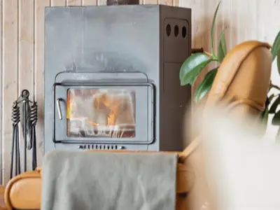 a oven with a fire in it in a room at Holiday Home Gidske - 300m from the sea by Interhome in Blokhus
