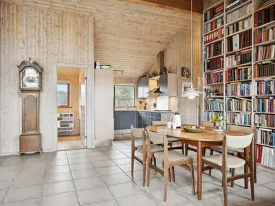 a kitchen and dining room with a table and chairs at Holiday Home Gidske - 300m from the sea by Interhome in Blokhus