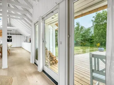 a kitchen and dining room with a sliding glass door at Holiday Home Verner - 900m from the sea by Interhome in Fjerritslev