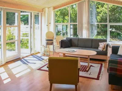 a living room with a couch and a table at Holiday Home Gisa - 400m from the sea by Interhome in Fjerritslev