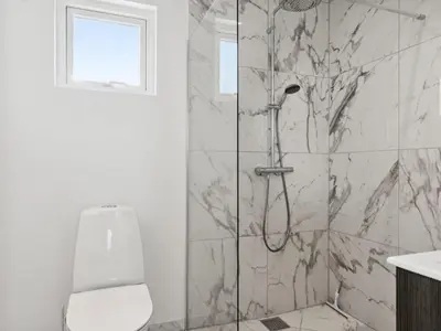 a bathroom with a shower with a toilet and a sink at Holiday Home Scalli - 1-5km to the fjord by Interhome in Farsø