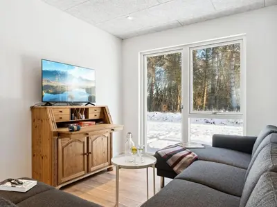 a living room with a couch and a window at Holiday Home Scalli - 1-5km to the fjord by Interhome in Farsø