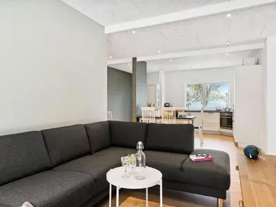 a living room with a couch and a table at Holiday Home Scalli - 1-5km to the fjord by Interhome in Farsø
