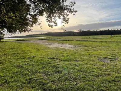 a field with a dirt road in the grass at 4 star holiday home in Thisted-By Traum in Thisted