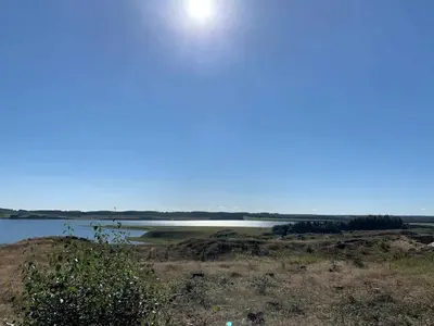 a body of water with the sun in the sky at 4 star holiday home in Thisted-By Traum in Thisted